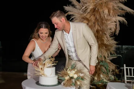 Sweet beginnings and unforgettable memories. Hand in hand, the newlyweds share their first slice of cake together against a lush bohemian backdrop, celebrating the start of a beautiful life ahead in Puerto Vallarta