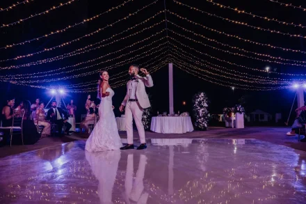A magical first dance under a sky full of glowing lights. Smiling and moving together in perfect harmony, the newlyweds light up the dance floor, creating an unforgettable highlight of their wedding reception in Puerto Vallarta