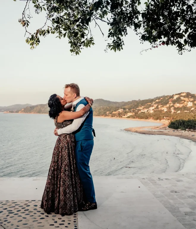 Standing high above the coast where the ocean whispers to the shore, wrapped tightly in an embrace that feels like coming home. A breathtaking, panoramic kiss captured high above Puerto Vallarta—a pure statement of romantic elegance and everlasting devotion