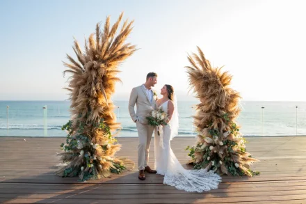 Framed by towering pampas grass and the serene horizon of the Pacific, the newlyweds share a quiet, adoring look. A picture-perfect moment of bohemian elegance and everlasting romance captured along the coastline of Puerto Vallarta