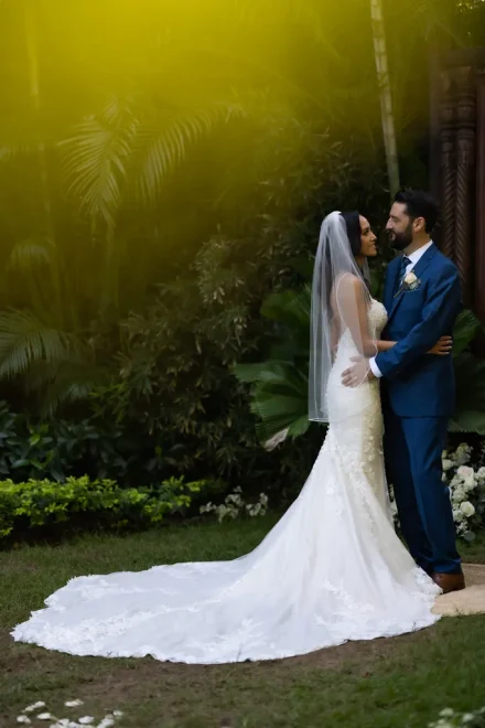 A quiet, romantic moment enveloped in natural tropical beauty. Holding each other close amidst lush greenery, the couple shares a sweet gaze that encapsulates the pure joy and magic of their special day in Puerto Vallarta