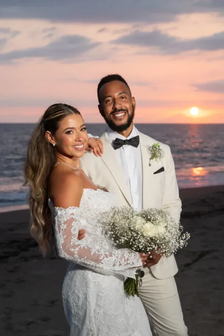 A breathtaking portrait glowing under the golden light of dusk. Standing together as the sun dips below the ocean horizon, the couple radiates serene happiness on the tranquil shores of Puerto Vallarta