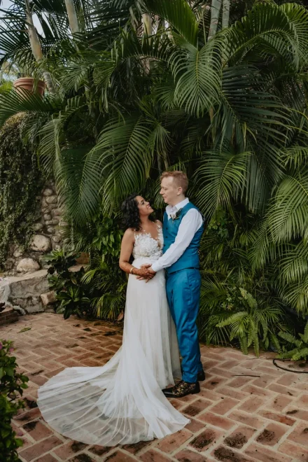 Tucked away in a lush tropical garden, lost in a moment meant only for them. With her delicate dress flowing across the terracotta tiles and palm leaves framing their embrace, this is where romance feels completely timeless in Puerto Vallarta