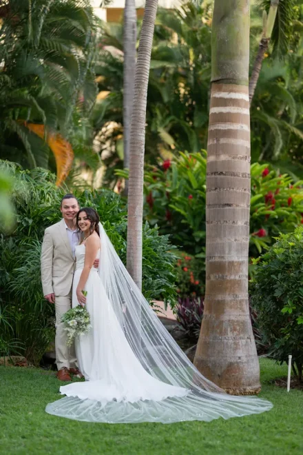 The serene beauty of a love enveloped by nature. Featuring a breathtaking cathedral veil flowing across lush tropical greenery, this romantic portrait captures the quiet, joyous harmony of your first moments together as husband and wife in Puerto Vallarta