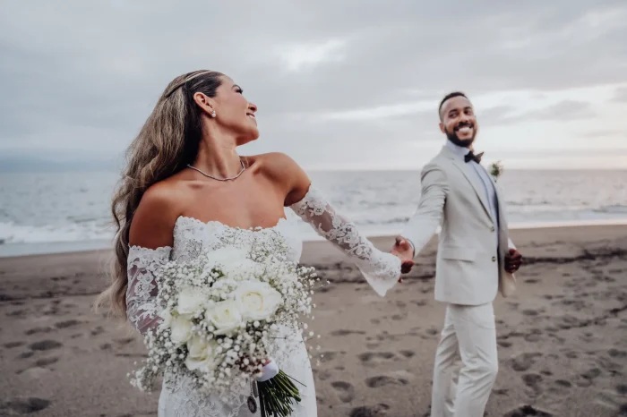 Pure happiness and effortless joy as they walk into forever together. Holding hands along the gentle shoreline, the bride beams with excitement, leading her groom through a beautiful sunset in Puerto Vallarta