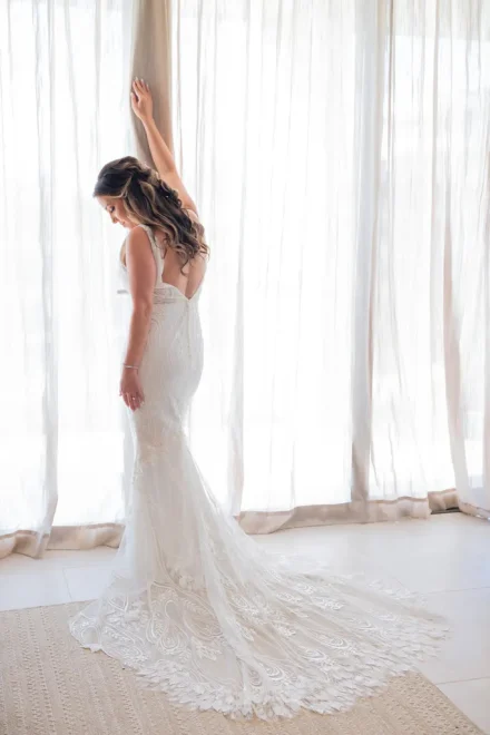 A quiet, breathtaking moment of beauty before saying "I do." Soft natural light highlights every intricate detail of the lace gown, capturing timeless elegance and the quiet grace of a destination bride in Puerto Vallarta