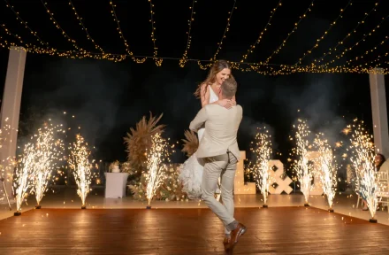 A breathtaking entrance into married life under a canopy of warm fairy lights and sparkling fireworks. Lifted high in celebration and joy, this enchanting moment captures the electric magic of dancing the night away in Puerto Vallarta