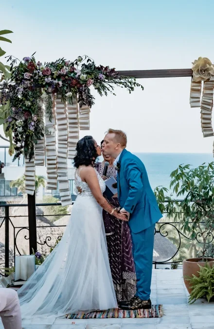 The unforgettable moment you seal your promises with a kiss. Framed by delicate floral design and the endless expanse of the ocean, every heart skips a beat as your forever journey begins in Puerto Vallarta