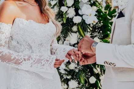 A sacred promise sealed in timeless elegance. The intimate moment of exchanging wedding rings, capturing eternal commitment against a lush backdrop of tropical blooms in Puerto Vallarta