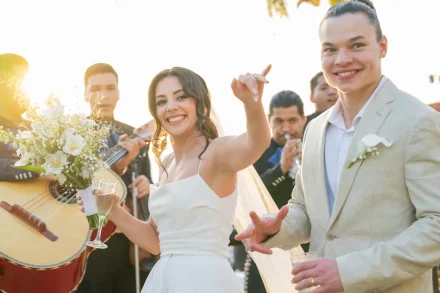 Pure, exuberant celebration! Raising your glass to live mariachi music bathed in Puerto Vallarta's golden sunset light, this candid moment catches the spontaneous energy and radiant happiness of celebrating your dream day