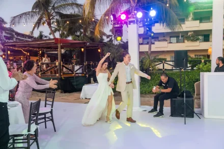 The grand entrance that sets the night on fire! With hands raised in joy, vibrant lights illuminating the dance floor, and loved ones cheering them on, this energetic moment marks the start of an unforgettable celebration in Puerto Vallarta