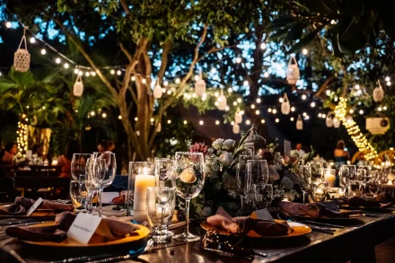As night falls, the celebration comes alive under a magical canopy of twinkling lights. With warm candlelight reflecting off crystal glasses and lush floral centerpieces, every detail creates an intimate, dreamlike ambiance for an evening reception in Puerto Vallarta
