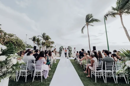 A breathtaking tropical dream brought to life. Surrounded by lush palm trees, gentle ocean breezes, and loved ones, the couple exchanges vows along the scenic coastline of Puerto Vallarta