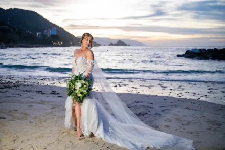 Radiance and coastal serenity. Capturing the magical moment as the sun dips below the horizon, our bride glows in her stunning lace gown. With Puerto Vallarta's iconic coastline and the gentle ocean waves as her backdrop, this portrait embodies the timeless beauty and effortless romance of a destination wedding paradise