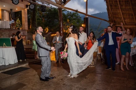 The celebration officially begins! Swept up in the energy of cheering friends and family, making your grand reception entrance under a tropical palapa in Puerto Vallarta sets the perfect mood for a night of dancing, laughter, and unforgettable memories