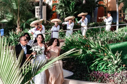 Rich traditions meet vibrant tropical color. Walking toward your forever surrounded by lush garden pathways while the spirited melodies of a live mariachi band fill the air captures the authentic festive spirit of a Puerto Vallarta destination wedding