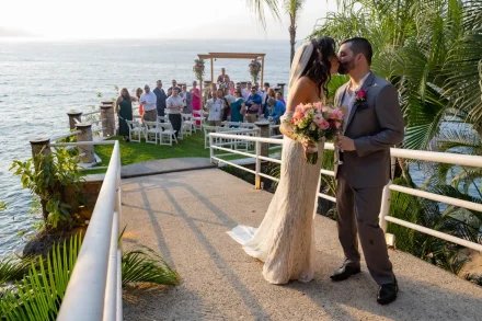 A private moment shared in the glow of new marriage. Stepping away down the walkway as your guests cheer behind you, stealing a quiet kiss high above the waves in Puerto Vallarta—this is the magic that memories are made of