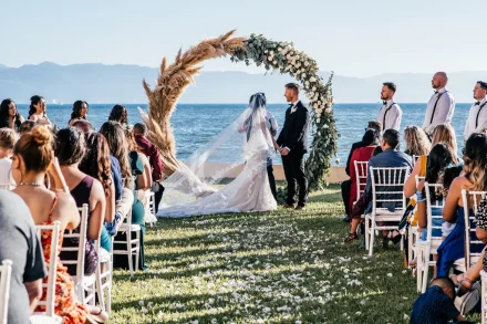 Exchanging vows where the endless ocean meets a clear blue sky. Framed by a circular arch of pampas grass and white florals, this breathtaking outdoor ceremony in Puerto Vallarta creates an unforgettable setting to begin your forever