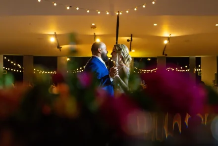 Lost in the magic of their first dance. Wrapped in a warm, ambient glow under twinkling string lights, the newly married couple shares a dreamy, romantic dance as night falls over their Puerto Vallarta reception