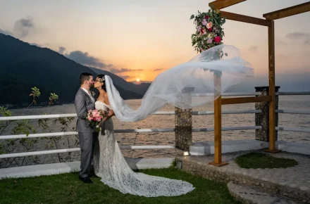 A breathtaking moment where time stands still. As the sun sets behind the coastal mountains, a gentle sea breeze catches the veil, framing an unforgettable sunset kiss over the waters of Puerto Vallarta